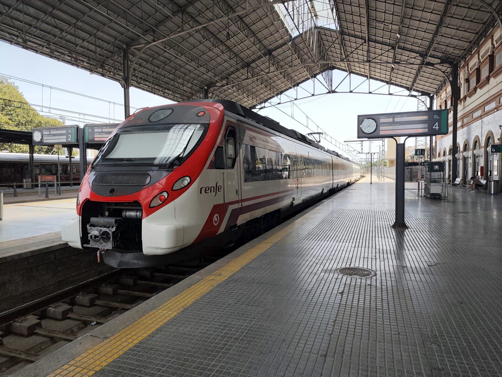 A modern commuter train waits at the platform of Jerez de la Frontera railway station.